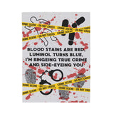 The Crime Scene Snuggle Lightweight Blanket for True Crime Lovers featuring a crime scene design and playful text.