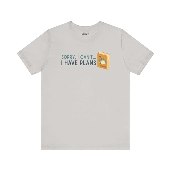 Soft tee with 'Sorry I Can't - I Have Plans' design, ideal for camping and book lovers.