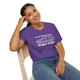 Smiling woman wearing a purple Proud Member of the Wagon Mafia t-shirt while sitting on a chair.