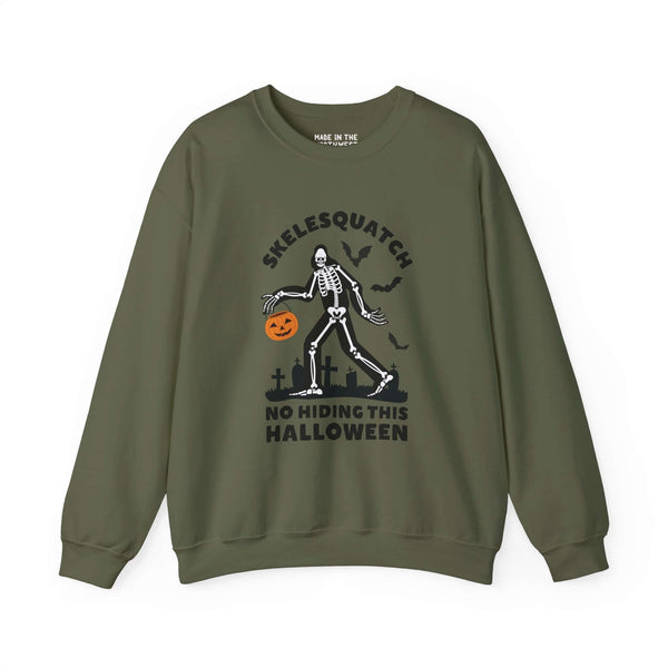 Skelesquatch Halloween sweatshirt featuring skeleton Sasquatch with trick-or-treat bucket, cryptid fun design on green fabric.