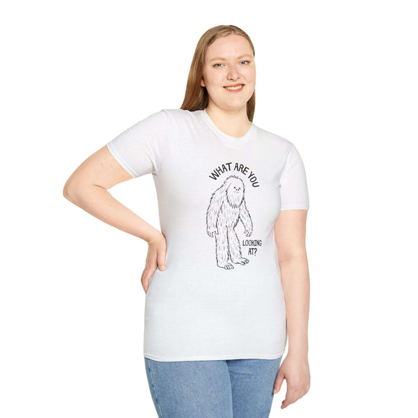 Model wearing a white What Are You Looking At t shirt featuring a funny sasquatch graphic.