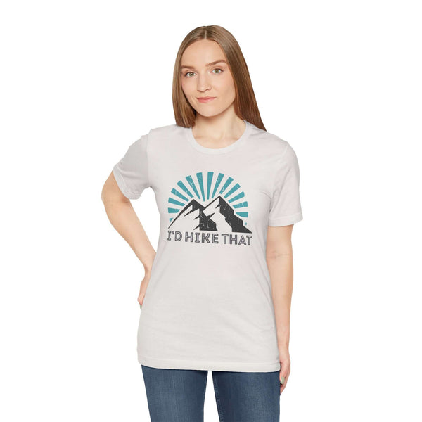 I’d Hike That T Shirt displayed on a model featuring a mountain design and a sunburst pattern, ideal for outdoor enthusiasts.