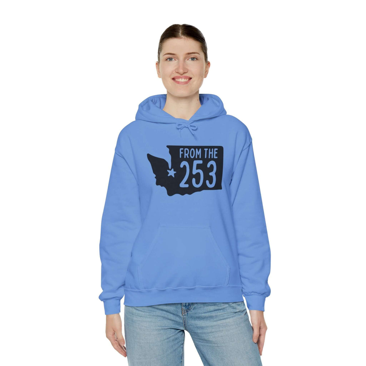 Woman wearing blue hoodie with "From the 253" text and Washington state silhouette design, showcasing Tacoma pride.