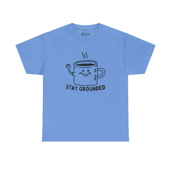 "Blue tee with 'Stay Grounded' text and a waving coffee mug illustration, perfect for coffee lovers seeking comfort and charm."