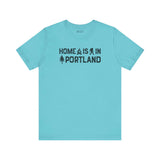 Home Is in Portland tee showcasing a blue shirt with illustrations and text emphasizing Rose City Pride.