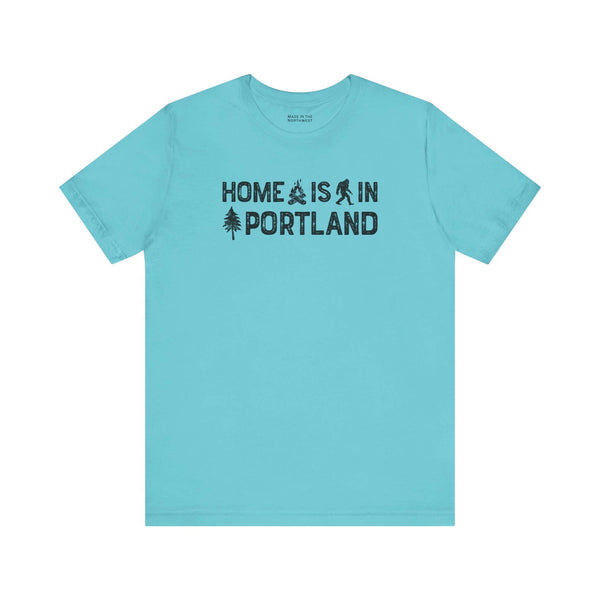 Home Is in Portland tee showcasing a blue shirt with illustrations and text emphasizing Rose City Pride.