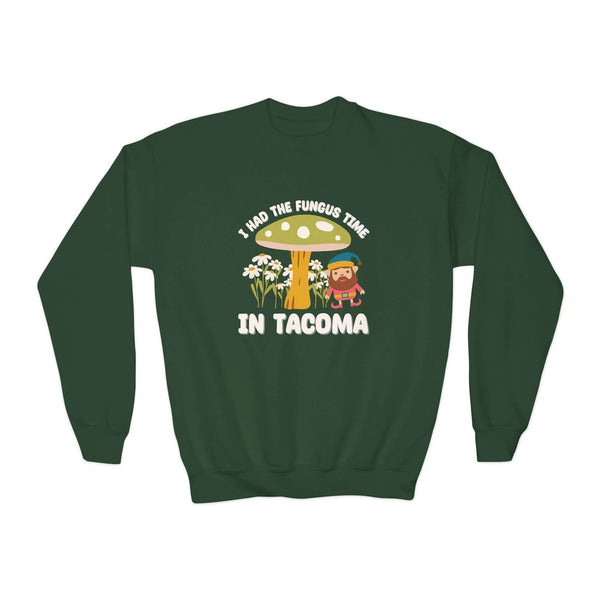 Green sweatshirt featuring 'I Had the Fungus Time in Tacoma' with mushroom house and gnome illustrations.