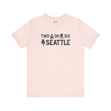 Two Oh Six Roots Premium Soft Tee in light color featuring Seattle area code design with axe and trees.