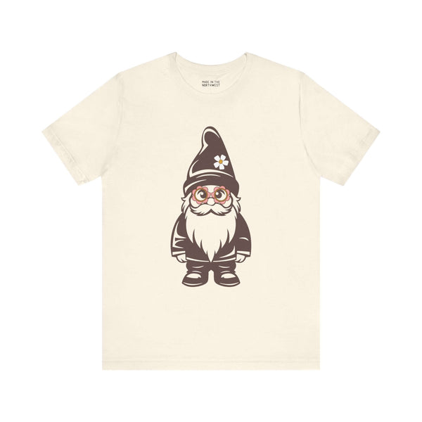 Beige tee featuring a cartoon hippie gnome with daisy glasses and hat, showcasing playful PNW style.