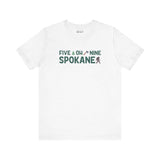 Five Oh Nine Roots Soft Tee with Spokane pride, featuring text and tree axe design on a white shirt.