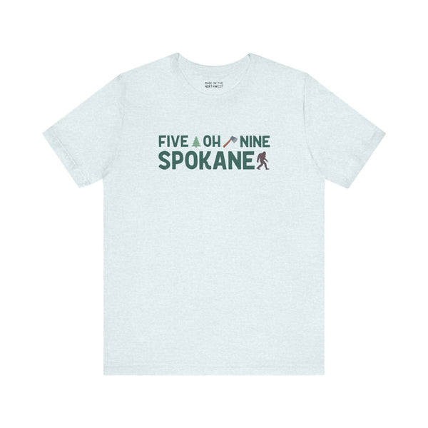 "Five Oh Nine Roots Soft Tee featuring Spokane area code text with axe and tree design, showcasing local pride and style."