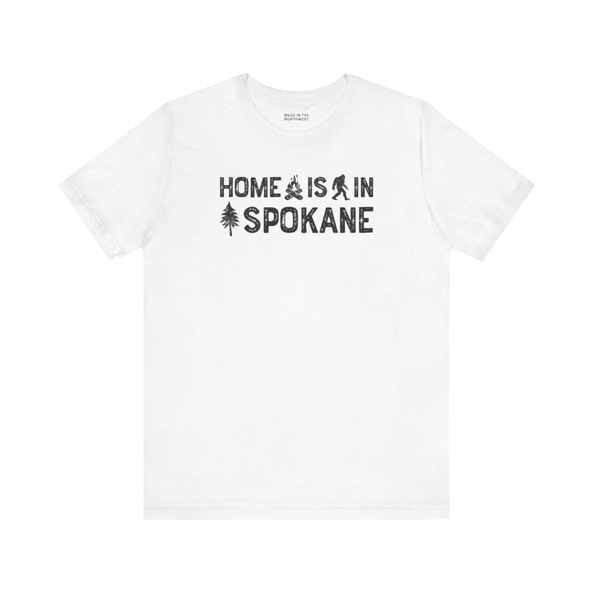 Home Is in Spokane Tee featuring campfire, Bigfoot, and tree illustrations on a white t-shirt.