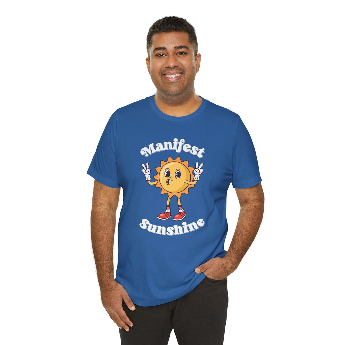 A person wearing a blue Manifest Sunshine T Shirt with a smiling cartoon sun design and peace signs, promoting positive vibes.