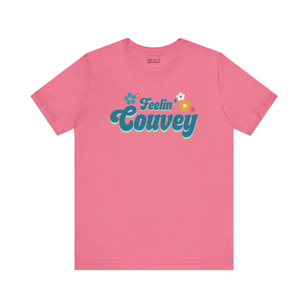 Feelin' Couvey Retro Soft Tee Embrace the vibrant spirit of Vancouver, Washington with our "Feelin' Couvey" Retro Tee! This playful design features the phrase "Feelin' Couvey" in a nostalgic 70s font, complete with colorful aqua and pink flowers. A fun tw