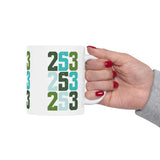 Hand holding a Two-Five-Three Pop Tacoma ceramic mug featuring vibrant 253 area code design.