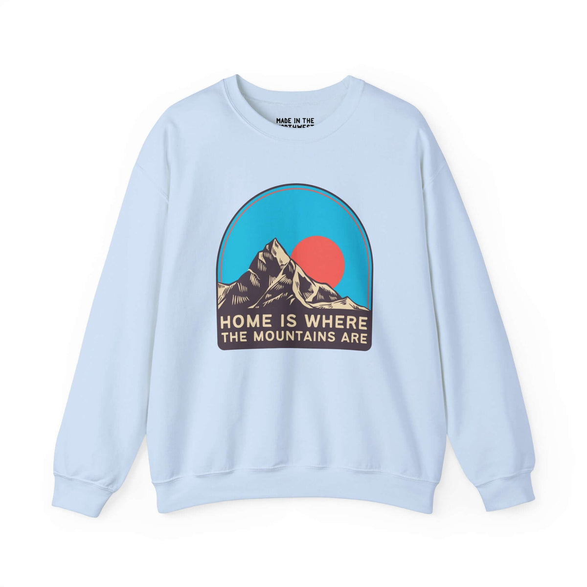 Light blue sweatshirt with "Home is Where the Mountains Are" graphic featuring colorful mountains and sky design. Perfect for mountain lovers.