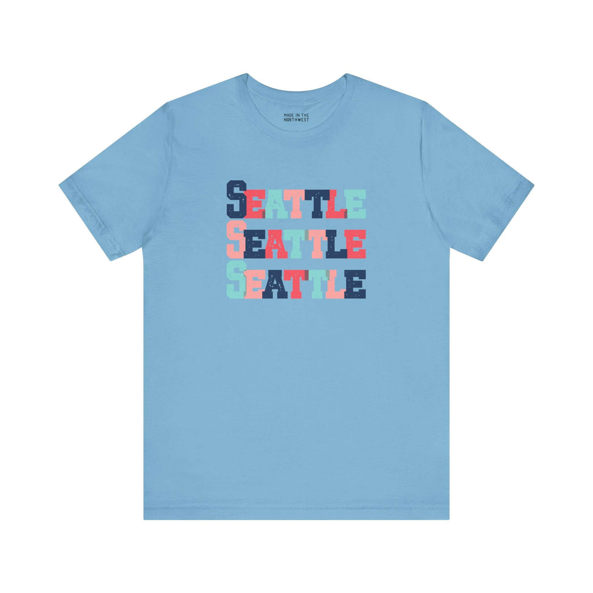 Bold Seattle trio design tee in blue featuring stacked colorful block-letter style.