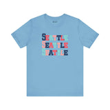 Bold Seattle trio design tee in blue featuring stacked colorful block-letter style.