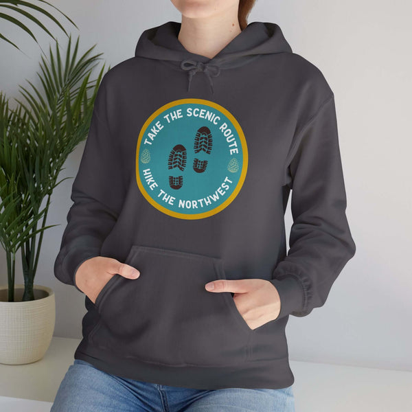 Person wearing "Take the Scenic Route - Hike the Northwest" hoodie, perfect for Pacific Northwest hiking adventures.