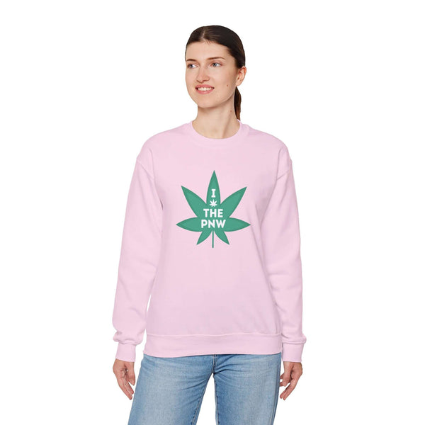 Woman wearing pink Chronic PNW Love sweatshirt with marijuana leaf graphic, celebrating Pacific Northwest culture.