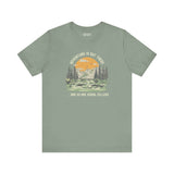 Premium soft tee featuring 'Adventure Is Out There... And So Are Serial Killers' graphic against a mountain backdrop.