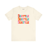 Bold Seattle Trio Tee featuring colorful block letters on a light background, perfect for city fans.
