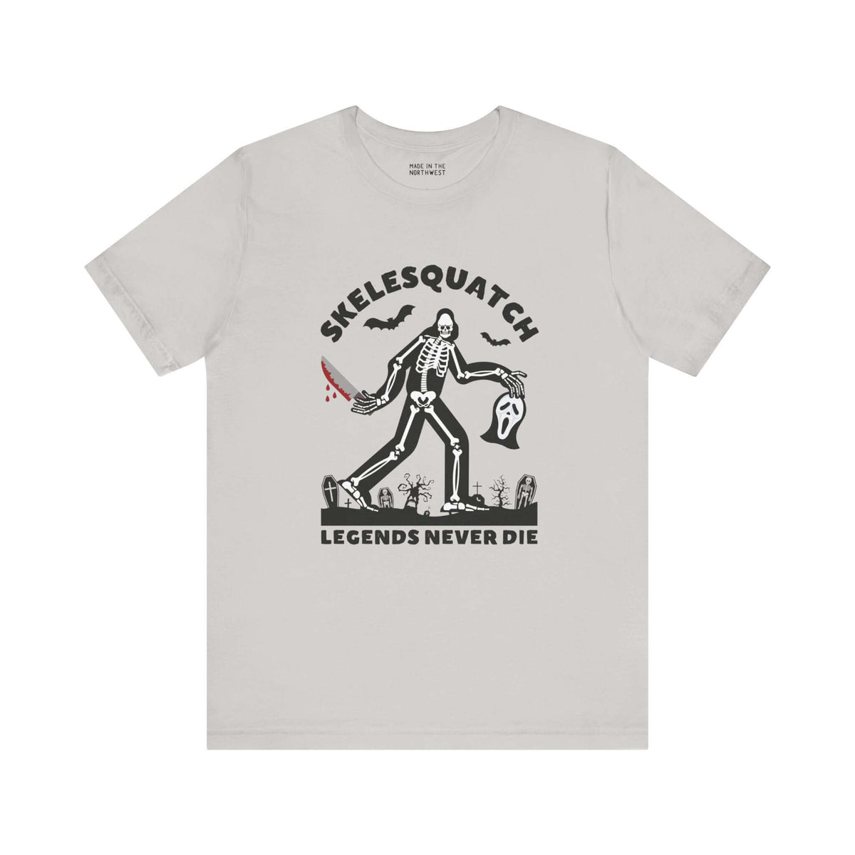 Skelesquatch Halloween tee featuring skeleton sasquatch with bloody knife and Scream mask in graveyard, perfect for cryptid and horror fans.