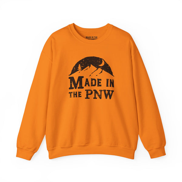 Made in the PNW sweatshirt in vibrant orange featuring a mountain and moon graphic.