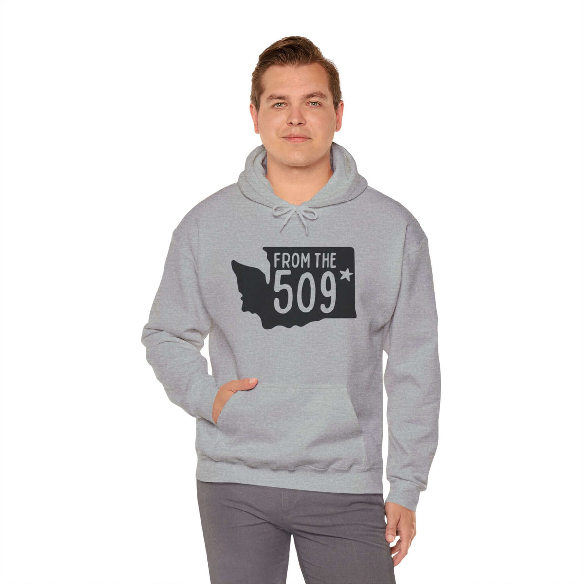 Man wearing "From the 509" hoodie with Washington state silhouette and Spokane star, showcasing local pride and area code.