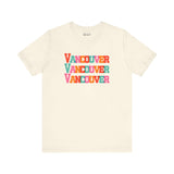 Bold Vancouver Trio Soft Tee with colorful block-letter design on cream fabric