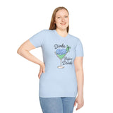 Model wearing a light blue Dinks Before Drinks T Shirt with a martini glass design and pickleballs.