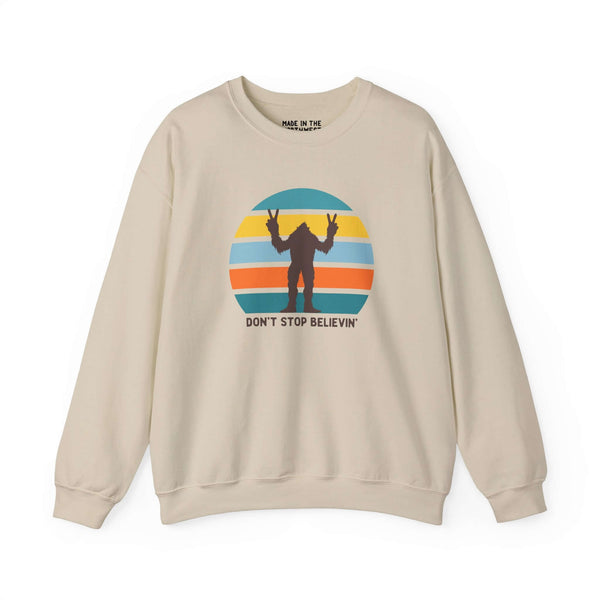 Don't Stop Believin' Bigfoot sweatshirt with playful sasquatch graphic and retro colors.