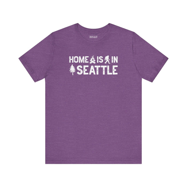 Home Is in Seattle Tee featuring a design with trees and Bigfoot in purple for Emerald City pride.