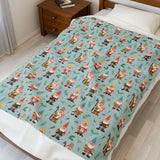 Garden Gnome Gathering Lightweight Cozy Blanket featuring playful gnomes and mushrooms on a bright blue background.