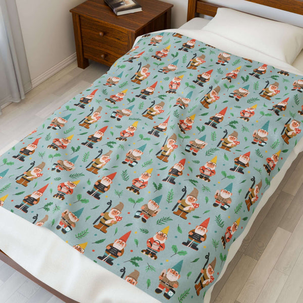 Garden Gnome Gathering Lightweight Cozy Blanket featuring playful gnomes and mushrooms on a bright blue background.