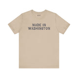 Beige tee with 'Made in Washington' in bold wood log font, celebrating Pacific Northwest pride.