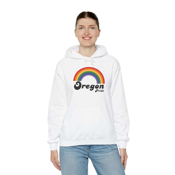 Woman wearing a white Oregon Pride hoodie featuring a vibrant rainbow design, celebrating love and inclusivity.