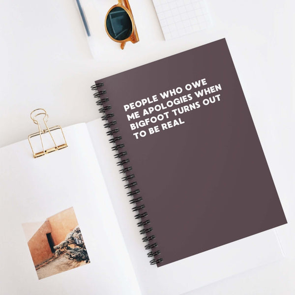 Spiral notebook titled 'People Who Owe Me Apologies When Bigfoot Turns Out to Be Real', perfect for keeping notes.