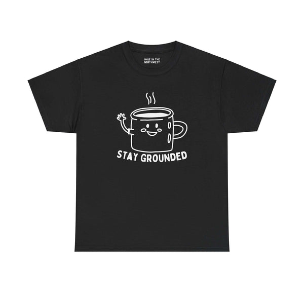 Black tee with cute illustrated coffee mug waving, text "Stay Grounded," perfect for coffee lovers seeking comfort and style.