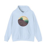 Pacific Peaks Modern Circle Hoodie with mountain design in muted colors on a light blue background.