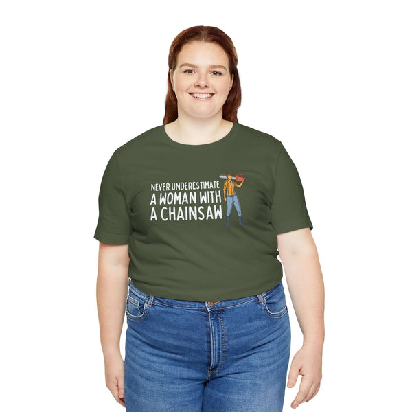 Model wearing 'Never Underestimate a Woman with a Chainsaw' green tee, showcasing confidence and strength.