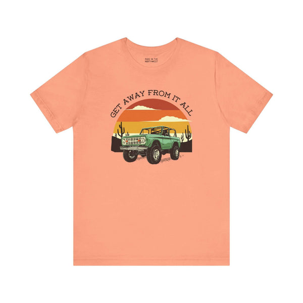 Get Away From It All vintage Bronco soft tee in coral featuring a classic Bronco and sunset design.