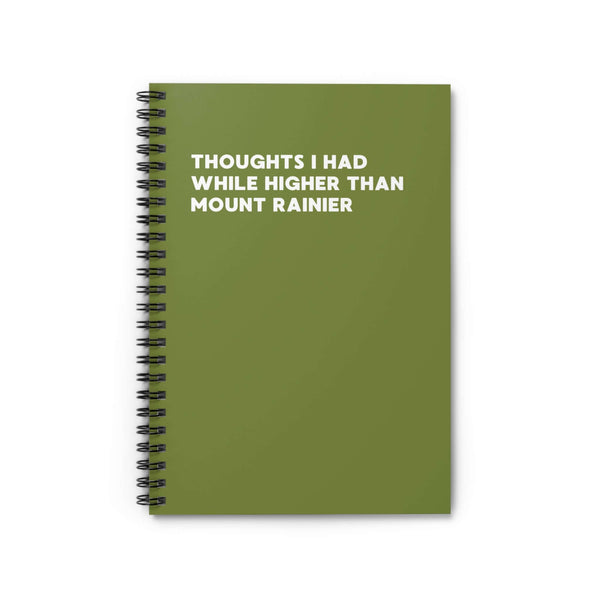 Spiral notebook with the title 'Thoughts I Had While Higher Than Mount Rainier' on a green cover.