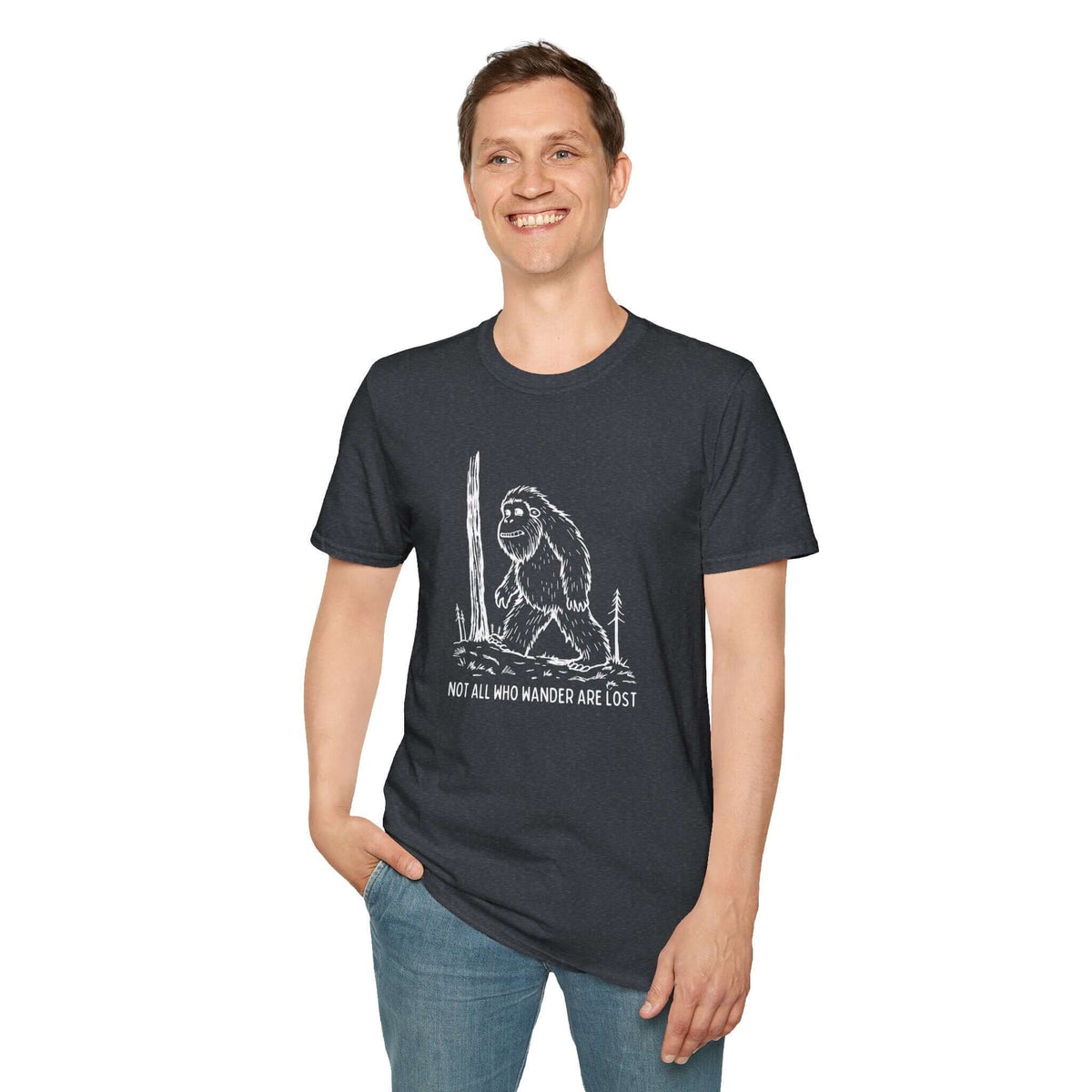 Man wearing Not All Who Wander Are Lost Bigfoot T-shirt featuring a Sasquatch design, ideal for outdoor enthusiasts.