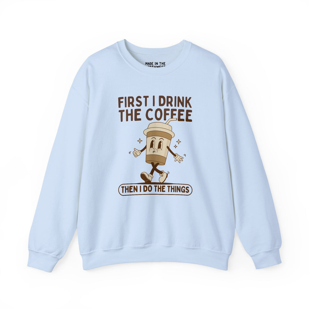 Light blue sweatshirt with coffee design and quote: 'First I Drink the Coffee Then I Do the Things'.
