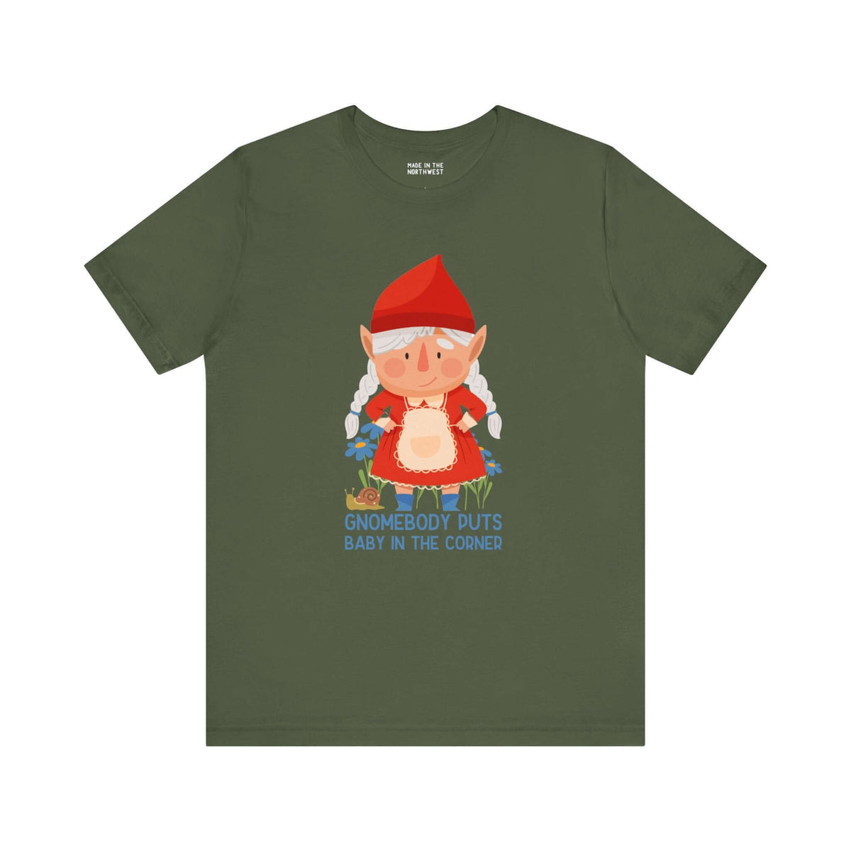 Olive green tee with adorable female gnome and "Gnomebody Puts Baby in the Corner" print, adding humor and charm to your style.