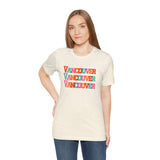 Woman wearing a bold and bright Vancouver trio soft tee with colorful block letters design.