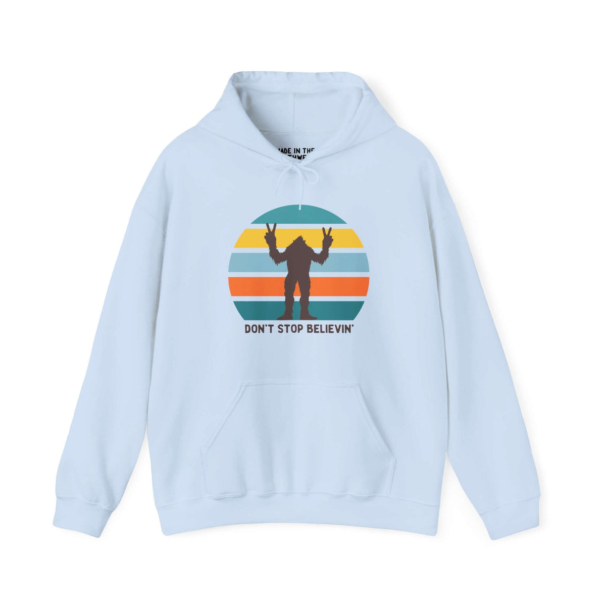 Bigfoot hoodie with "Don't Stop Believin'" phrase on light blue background, featuring colorful retro circle design.