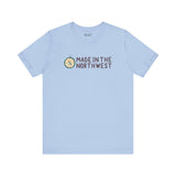 Light blue tee with 'Made in the Northwest' logo and compass design, perfect for Pacific Northwest enthusiasts and adventurers.