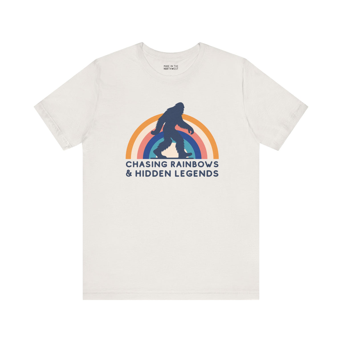 Chasing Rainbows and Hidden Legends tee featuring a Sasquatch graphic and vibrant rainbow design, perfect for PNW pride.